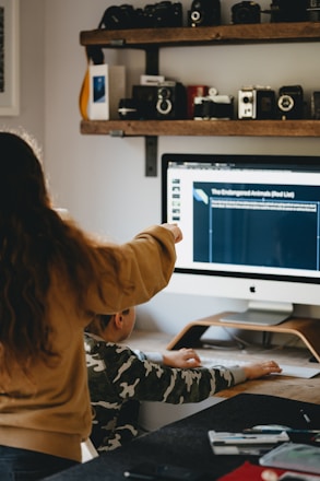 A caring volunteer using a laptop to report a missing child on the bachay platform.
