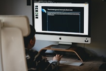 silver imac on brown wooden desk