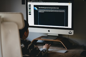 silver imac on brown wooden desk