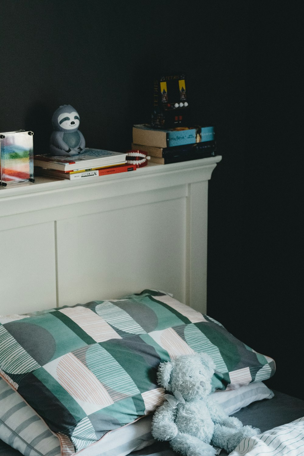 white and black panda plush toy on white wooden table