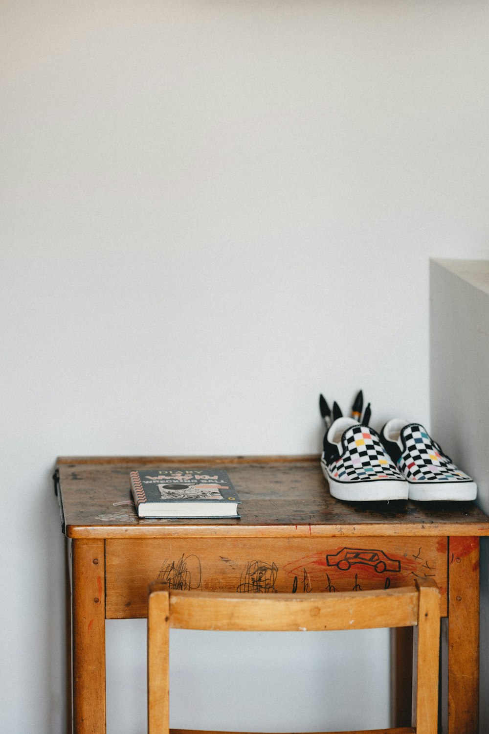 black and white polka dot house slippers on brown wooden table