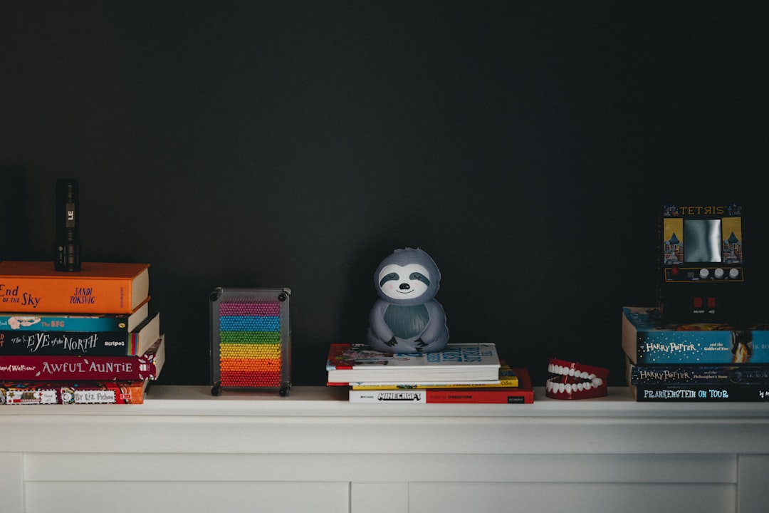 white and black panda ceramic figurine on white wooden shelf