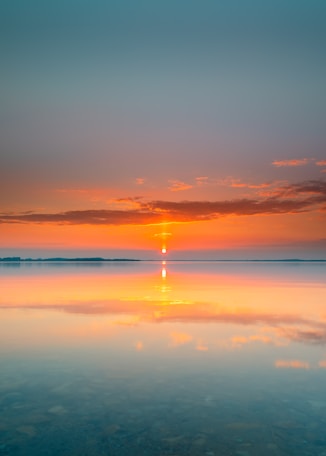 body of water during sunset