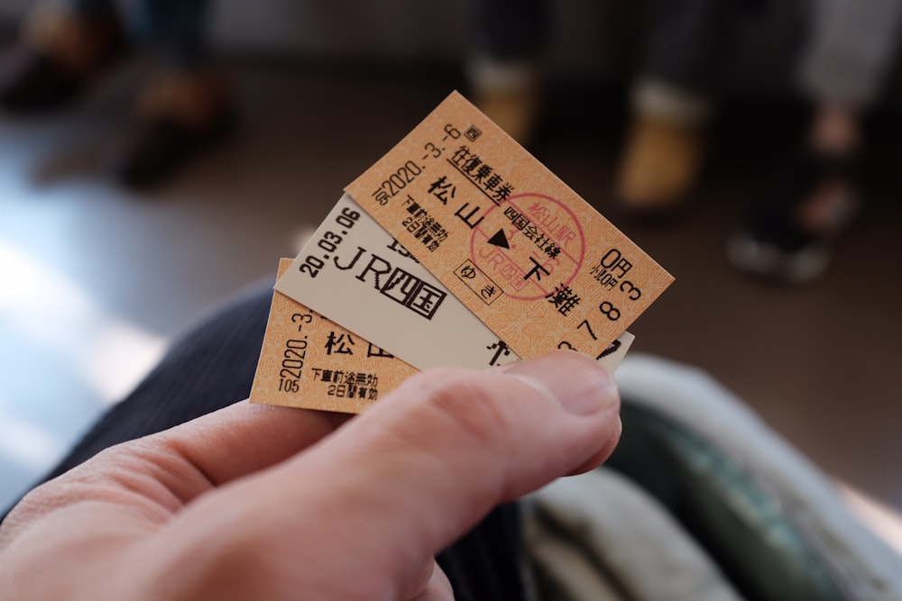 person holding brown and black card