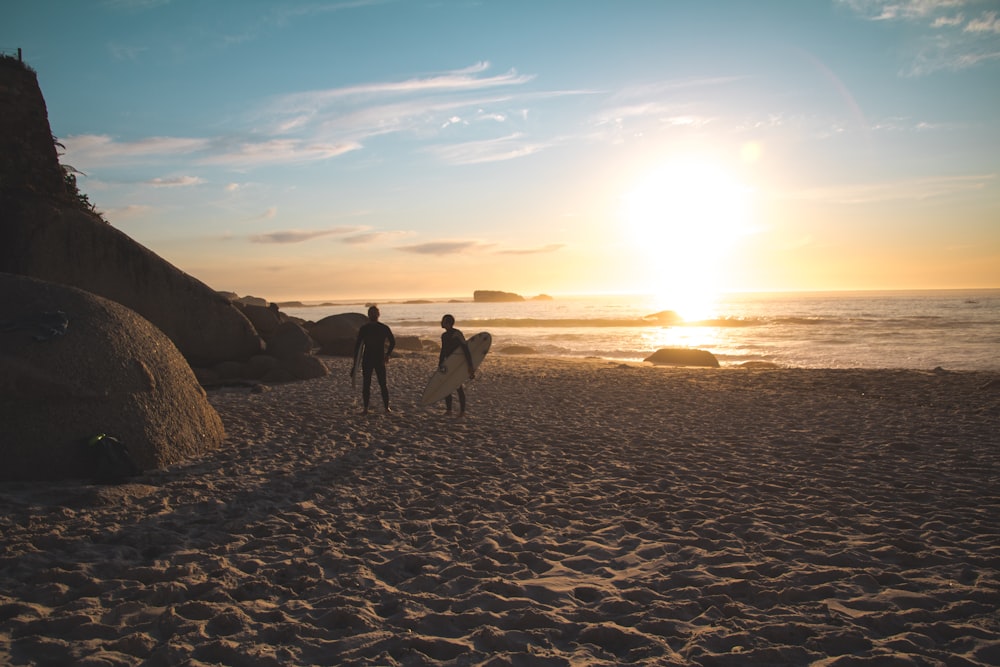 people walking on beach during sunset