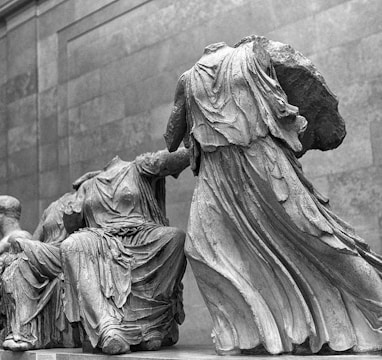 grayscale photo of man and woman statue