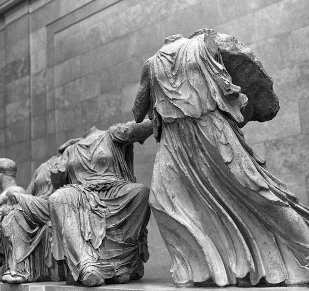 grayscale photo of man and woman statue