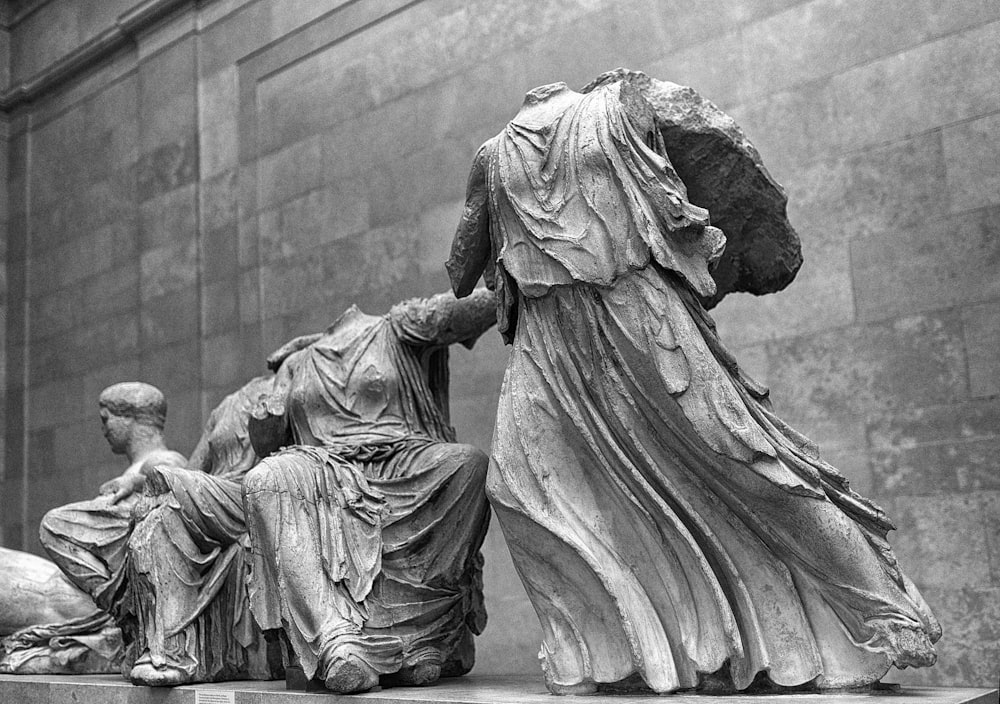 grayscale photo of man and woman statue