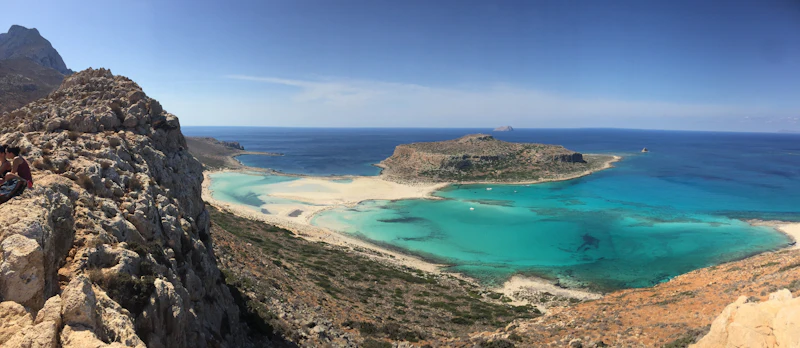 Turquoise bay and headland seen from rocky hills on Crete