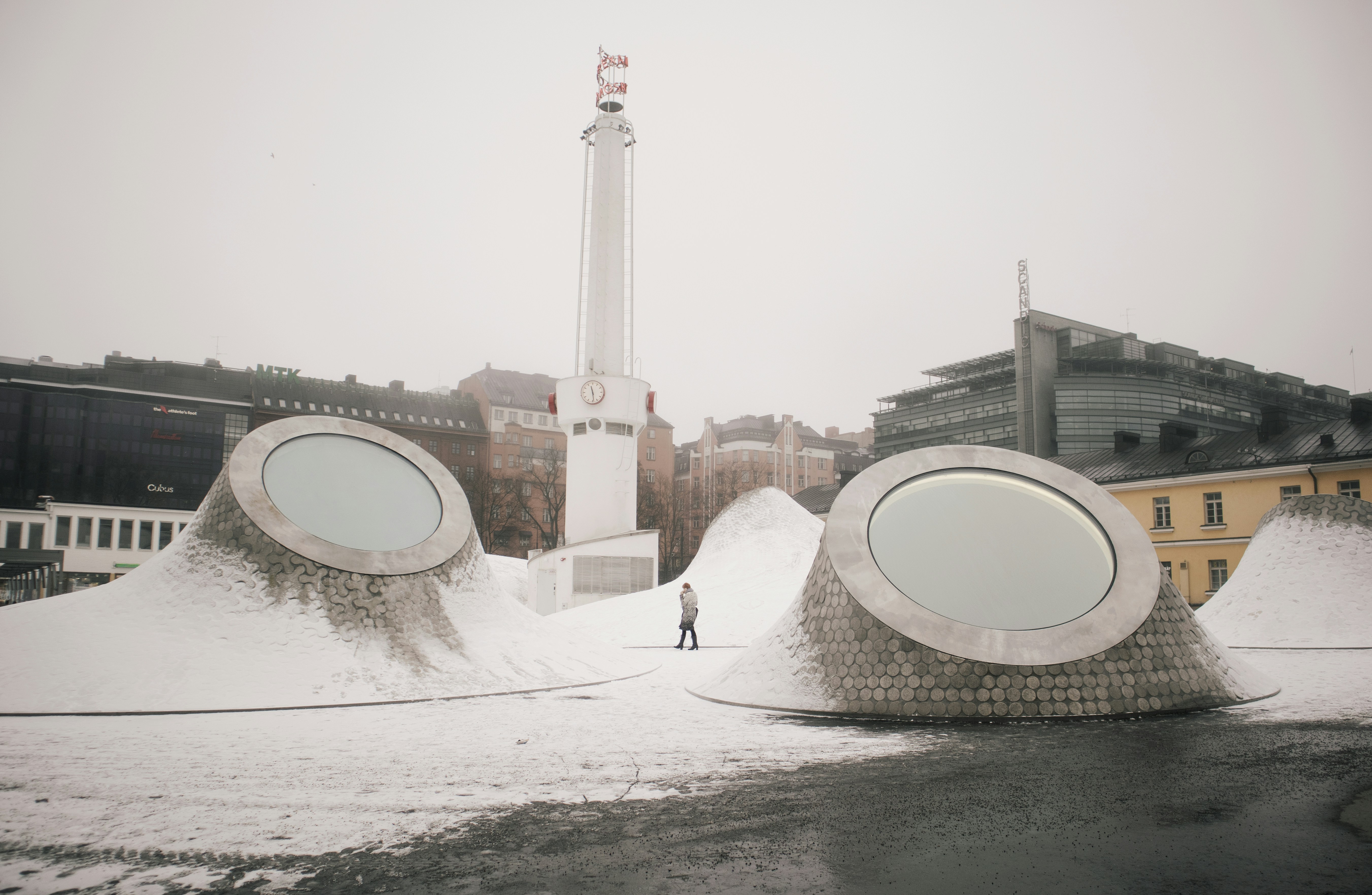 white and red lighthouse near brown concrete building during daytime