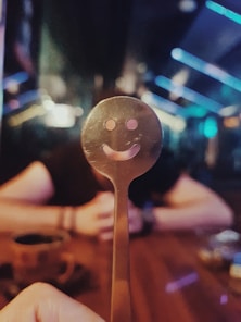 person holding silver spoon with light