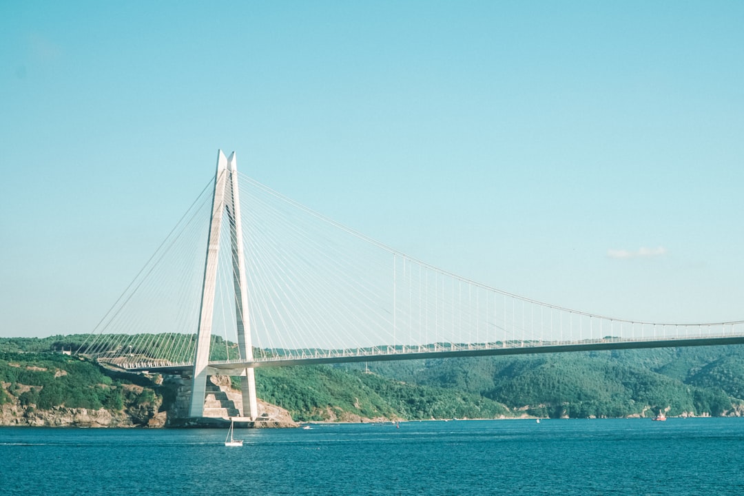 white bridge over blue sea under blue sky during daytime