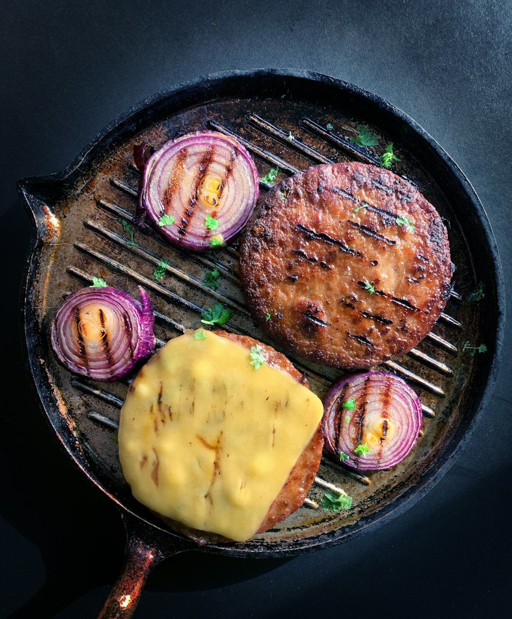 cooked meat on black round plate