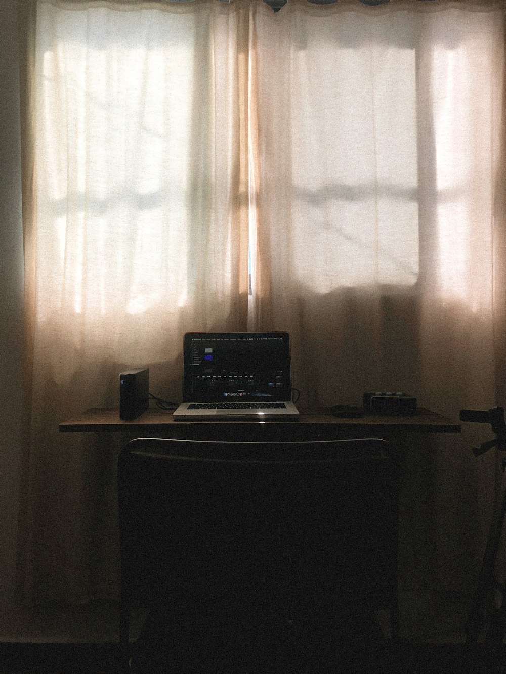 black laptop computer on brown wooden desk