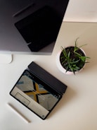 Person reviewing website layout on a tablet in a creative studio.