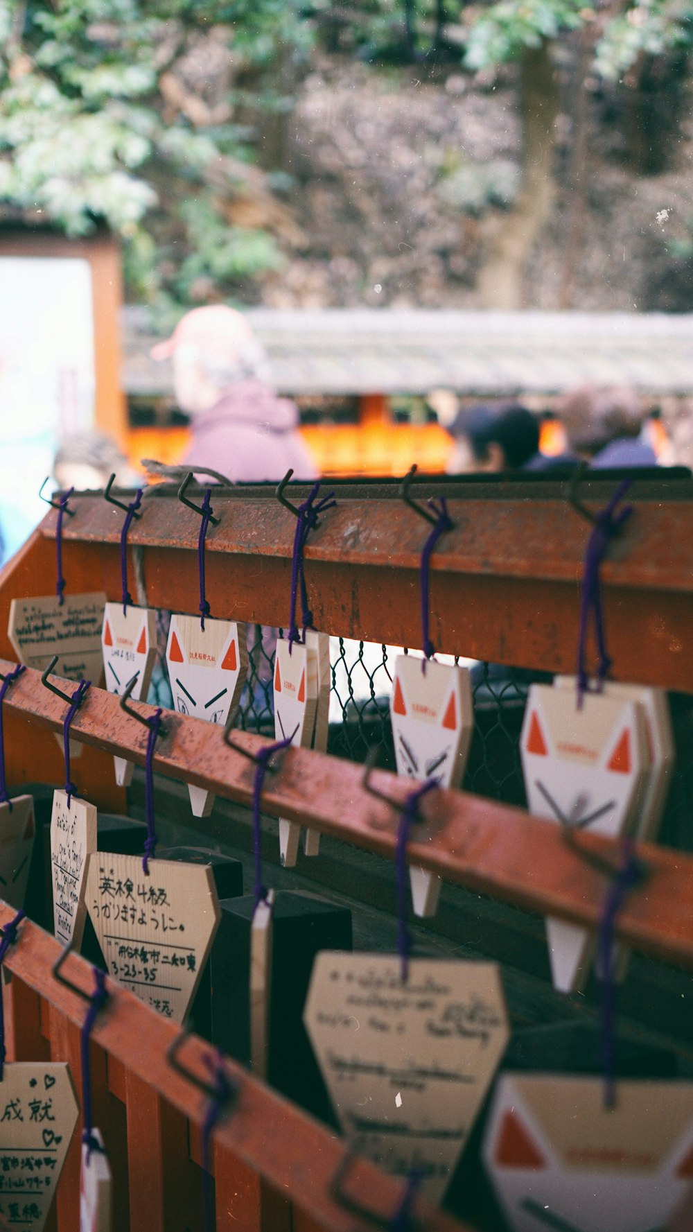 brown wooden hanging bridge with white and red cards