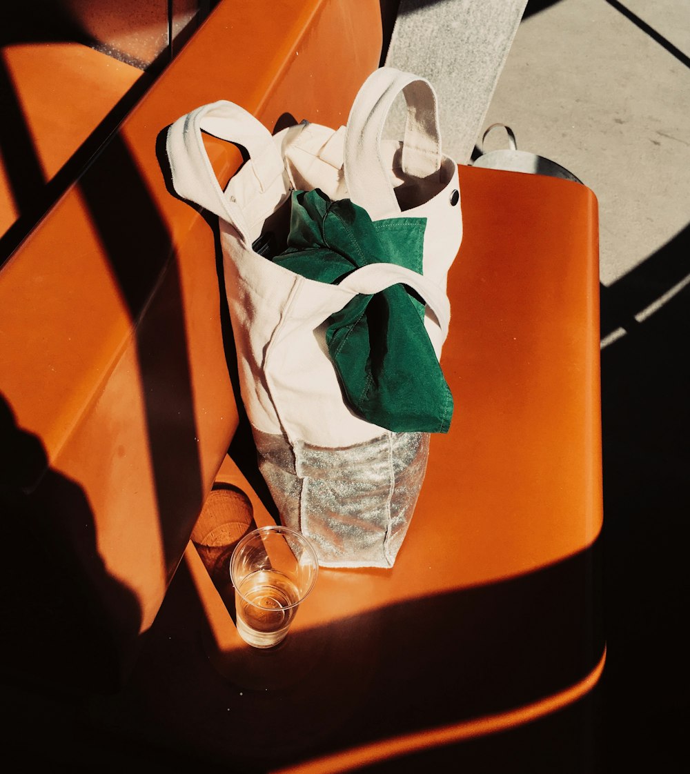 clear plastic bottle on orange plastic trash bin