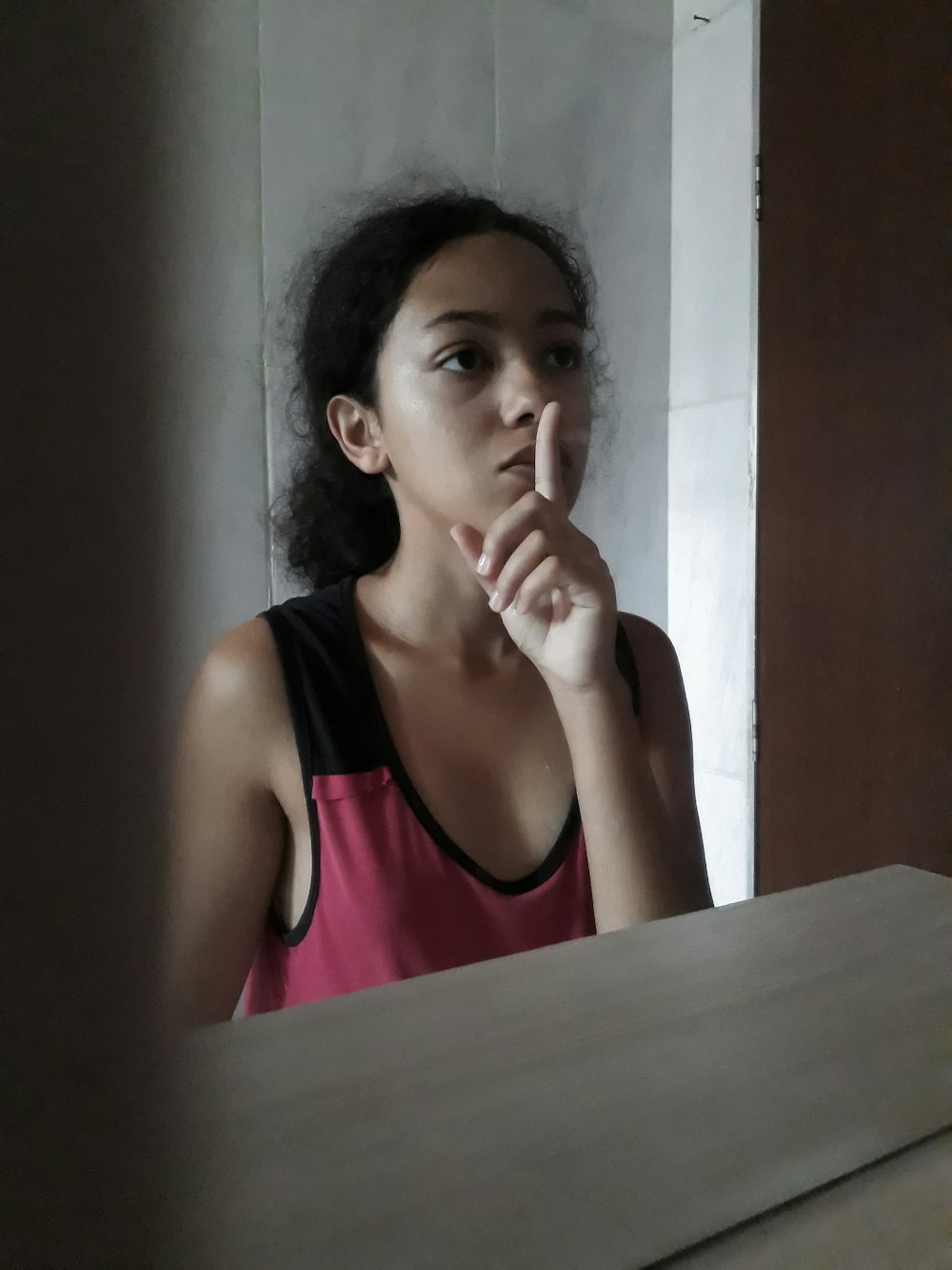 woman in pink tank top sitting at the table