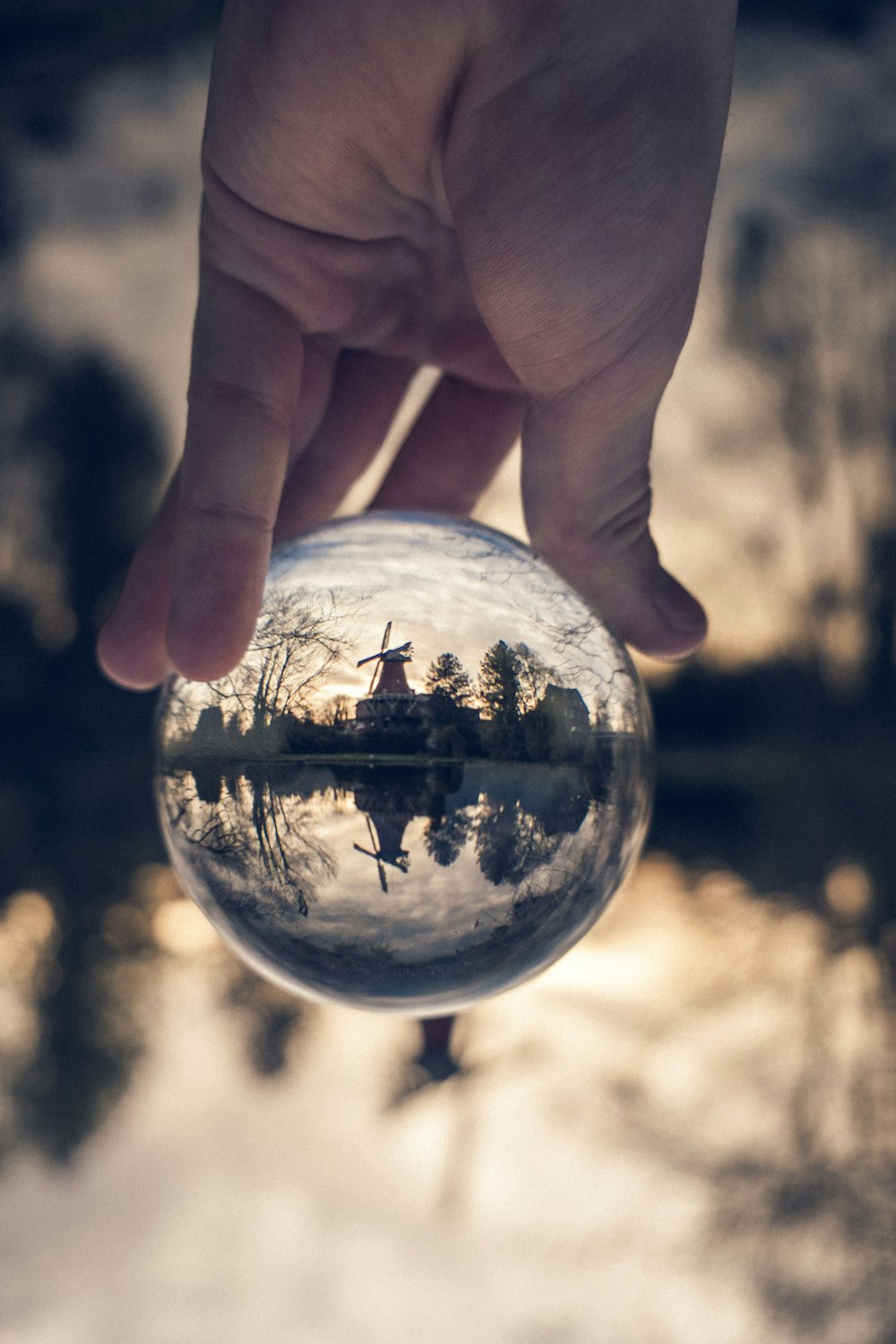 person holding clear glass ball