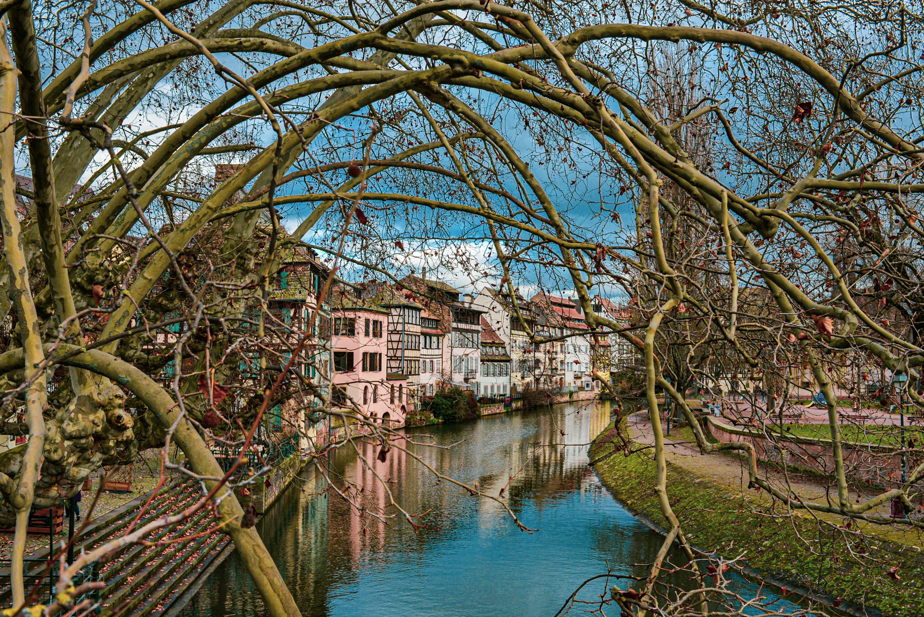 brown and white concrete building beside river during daytime