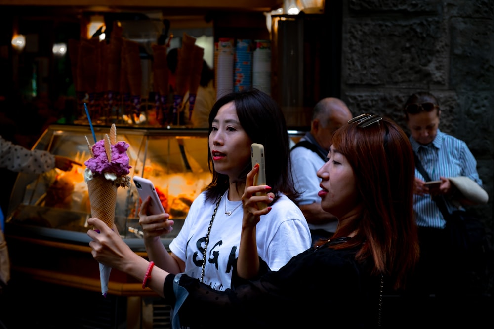 woman in black and white crew neck shirt holding ice cream cone