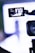 A video camera is focusing on a runway where a fashion show appears to be taking place. The camera's screen displays a person walking down the runway with bright lights and a blurred background.
