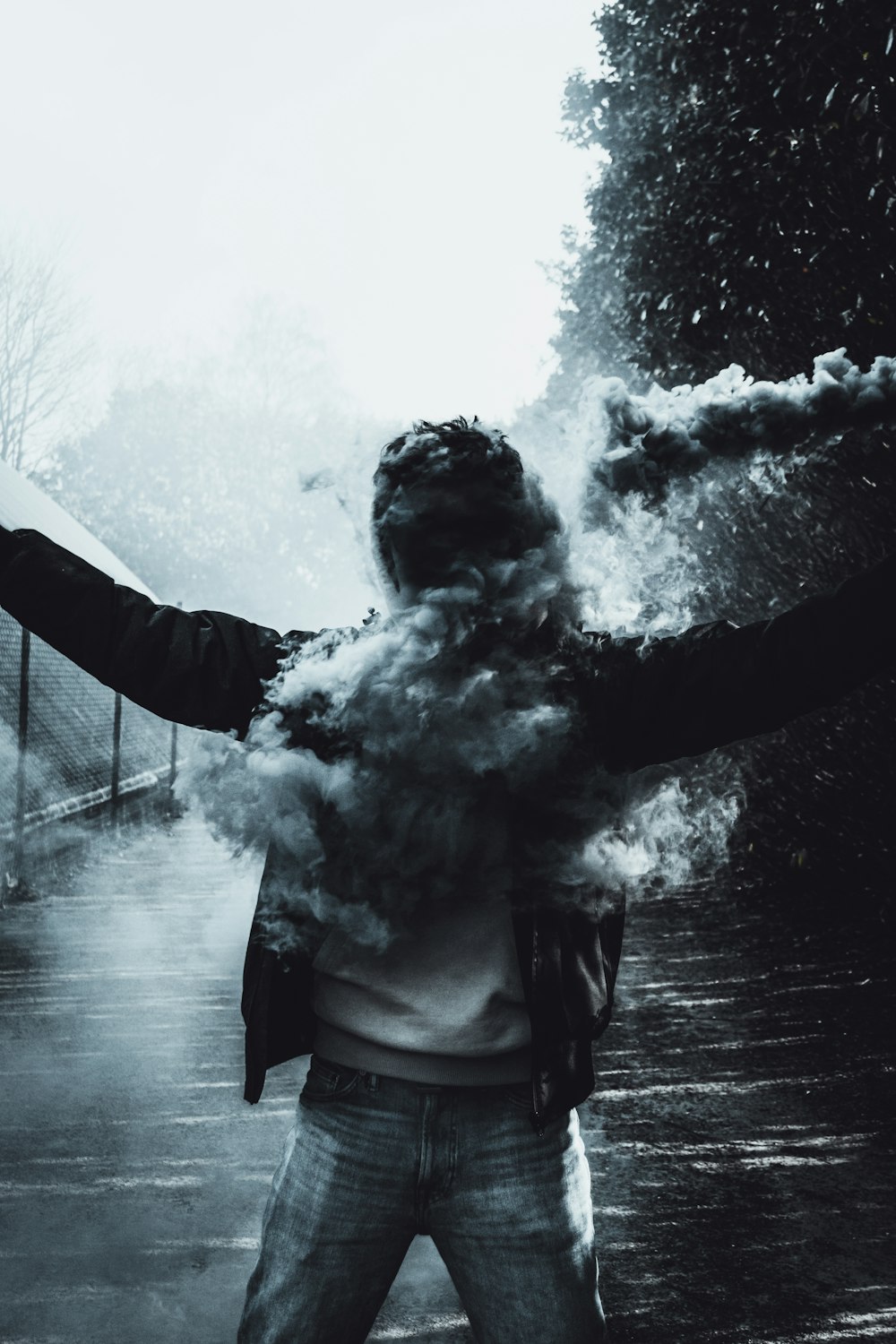 grayscale photo of woman in black jacket smoking