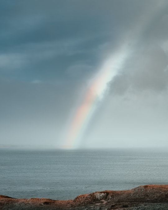 rainbow over the sea during daytime in Skye United Kingdom