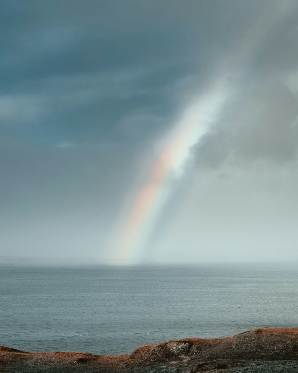 rainbow over the sea during daytime