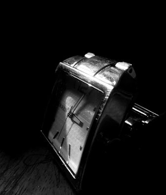 Artistic shot of a Philipe Ricci watch reflecting soft light on a charcoal background.
