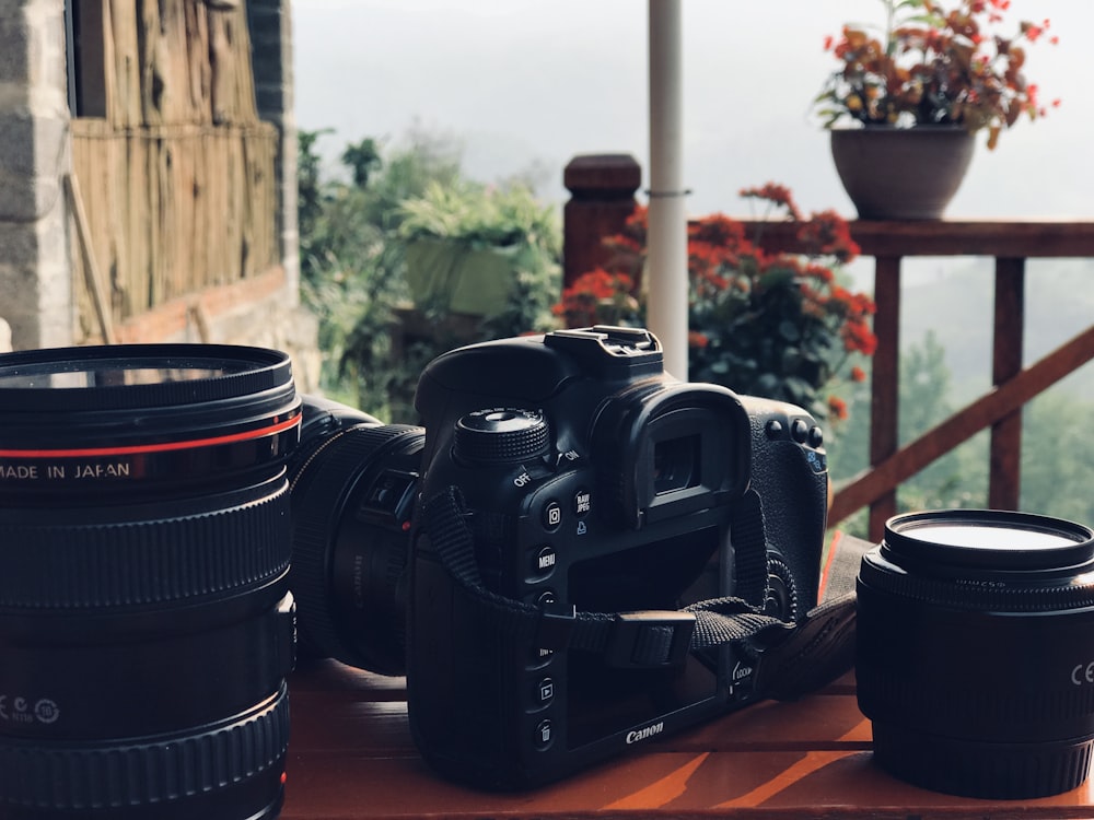 black nikon dslr camera on brown wooden table