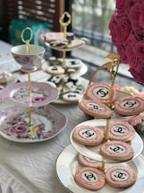 A beautiful high-tea setup with elegant teacups and snacks.