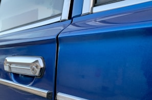 Side-by-side before and after of a car door panel restored to pristine condition