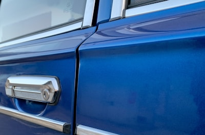 Close-up of a perfectly restored car door panel showing smooth, flawless trim work.