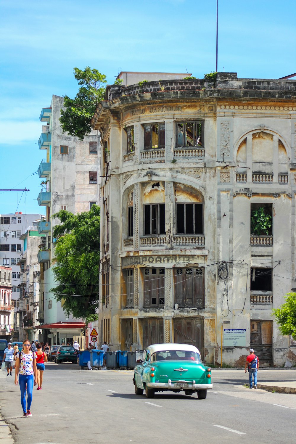 cars parked in front of brown concrete building during daytime