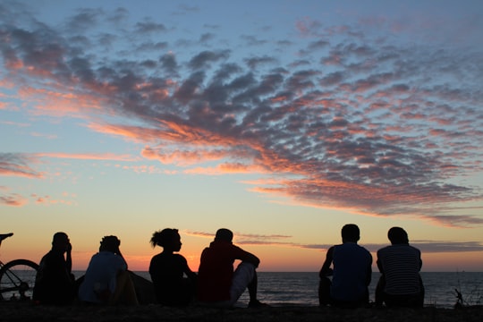 silhouette of people sitting on seashore during sunset in Morondava Madagascar