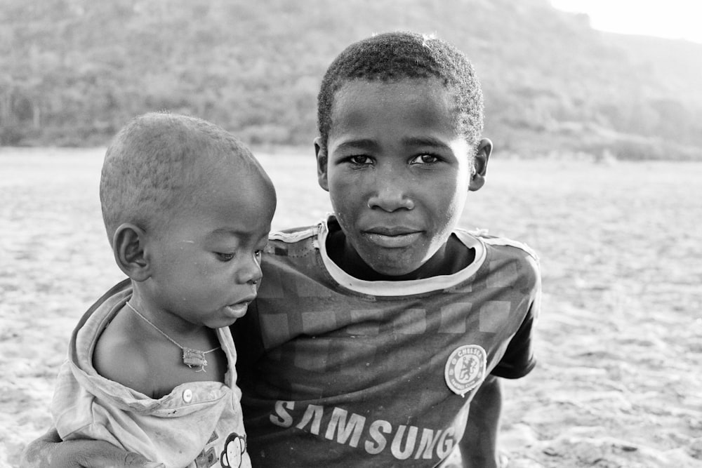 grayscale photo of 2 boys