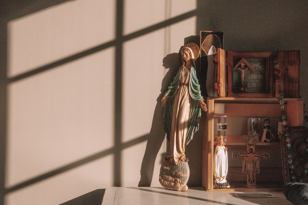 woman in green and brown dress figurine