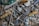 A collection of various mechanical tools and keys arranged in a chaotic manner. The image includes a variety of metallic objects such as locks, wrenches, keys, and a hand drill, among others. The items display signs of wear and use, giving a vintage and rustic feel.