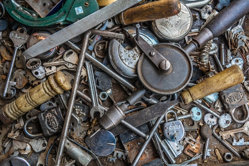 A close-up of heavy equipment keys hanging on a rack in a workshop.