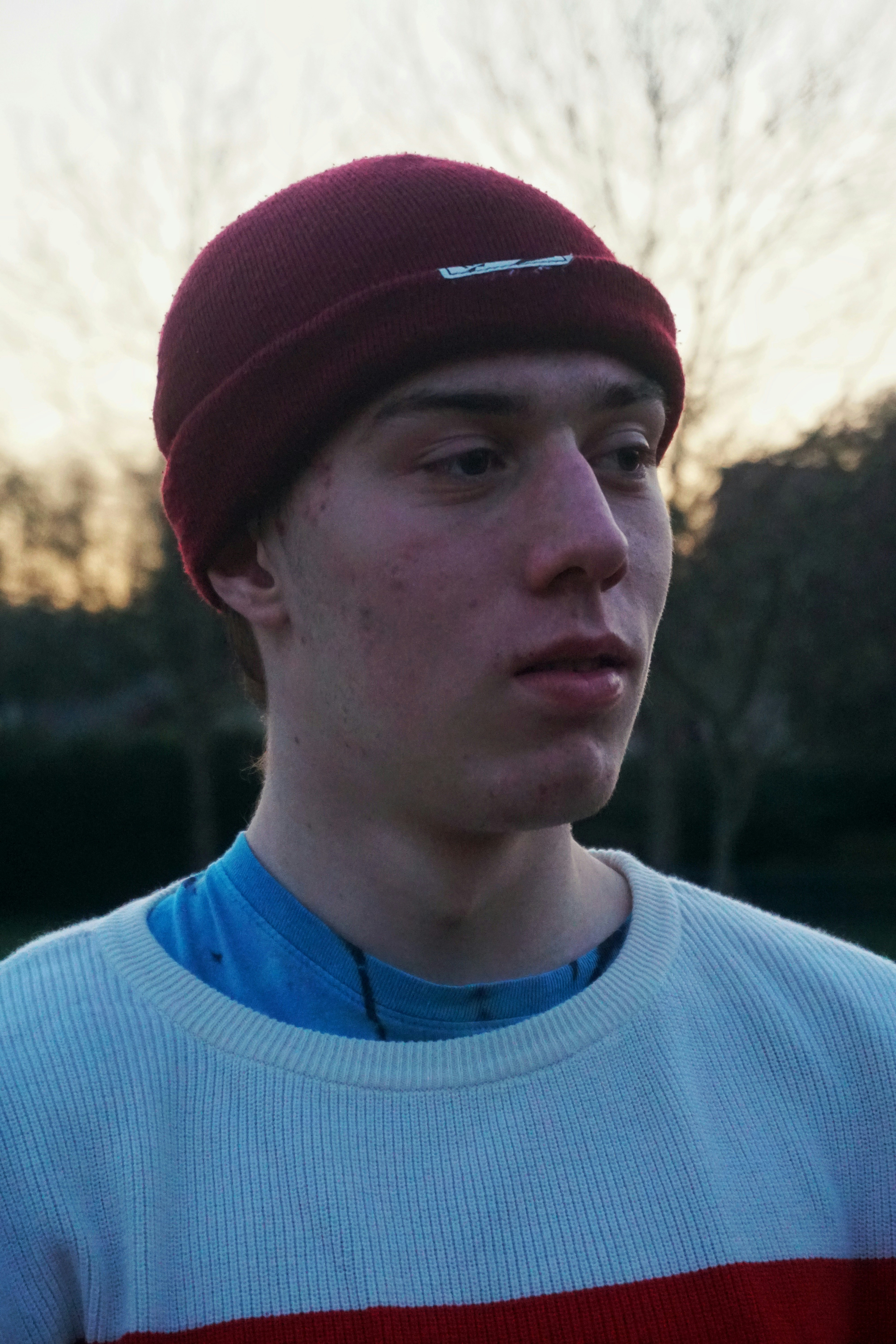 man in blue crew neck shirt and red knit cap