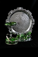 Close-up of an ornate silver-plated tray reflecting soft light.