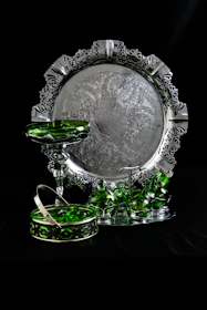 An elegant hand-hammered copper tray with golden accents resting on an olive green fabric.