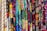 A vibrant assortment of fabrics is displayed, each featuring unique and intricate patterns. The patterns include various shapes, designs, and colors, ranging from geometric to floral motifs, set against both dark and bright backgrounds.