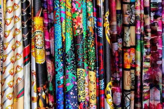 A vibrant display of traditional Indonesian batik fabrics in various colors and patterns.