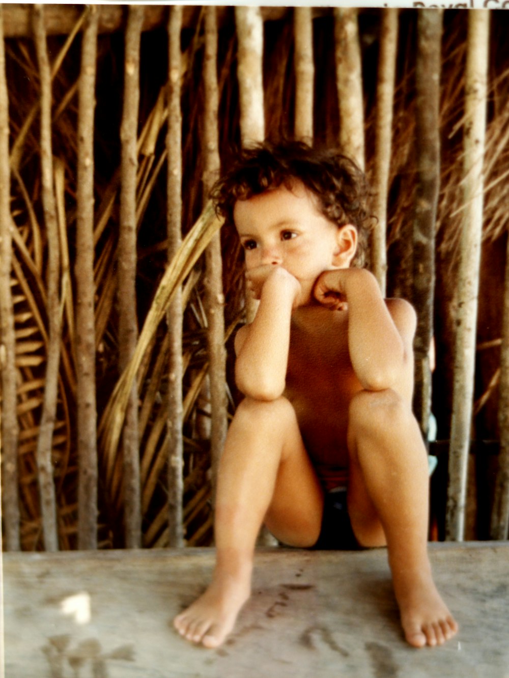 naked woman sitting on wooden floor