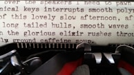 A close-up of a vintage typewriter with a half-finished poem on the paper.