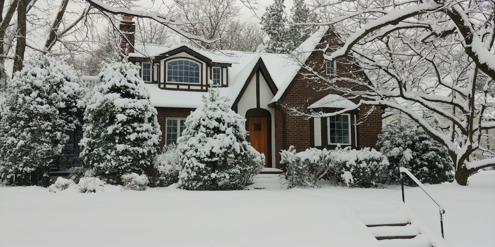 brown and white house covered with snow