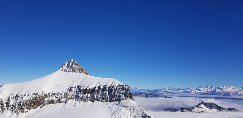 snow covered mountain under blue sky during daytime