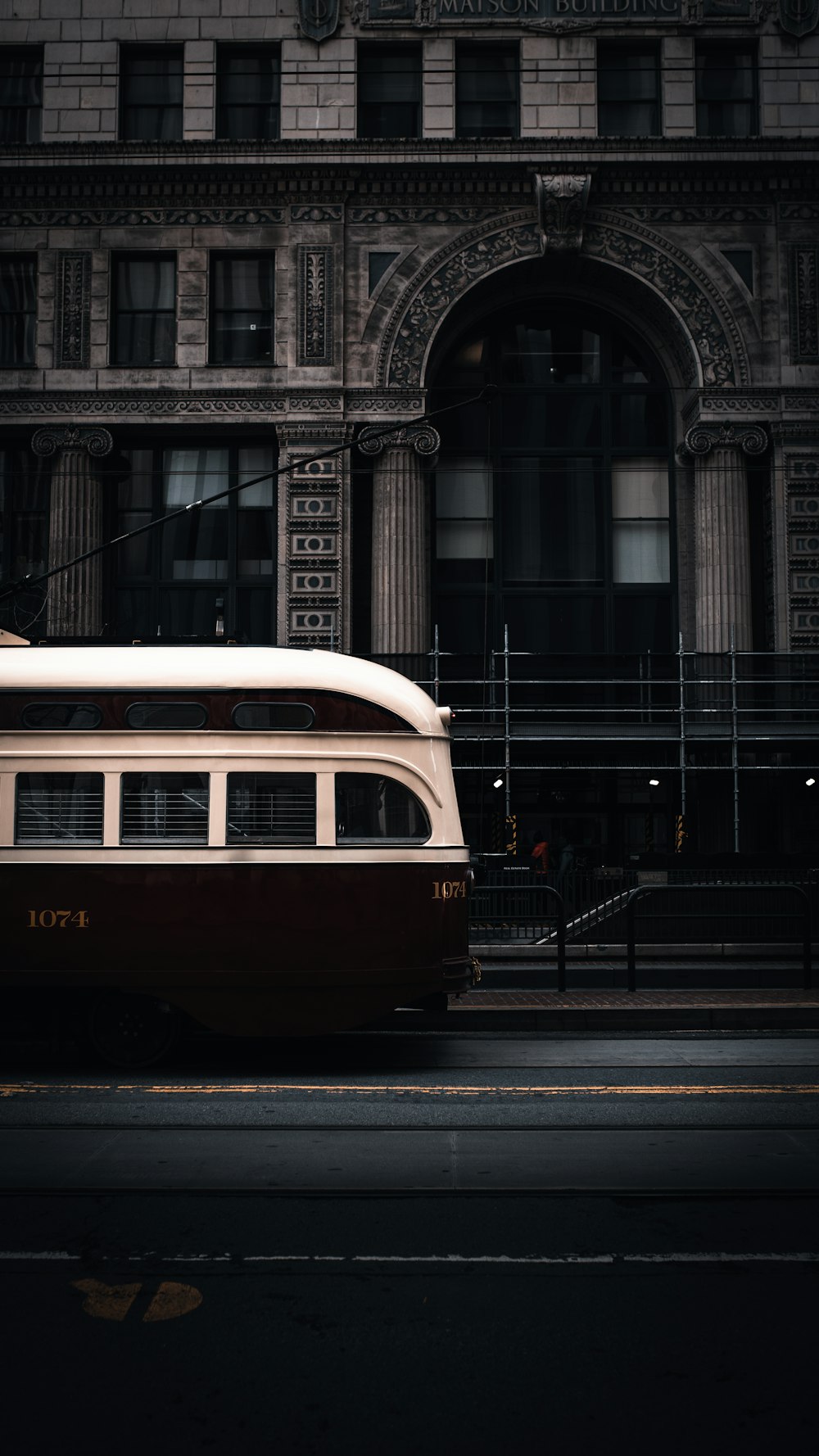 red and white bus on road during daytime